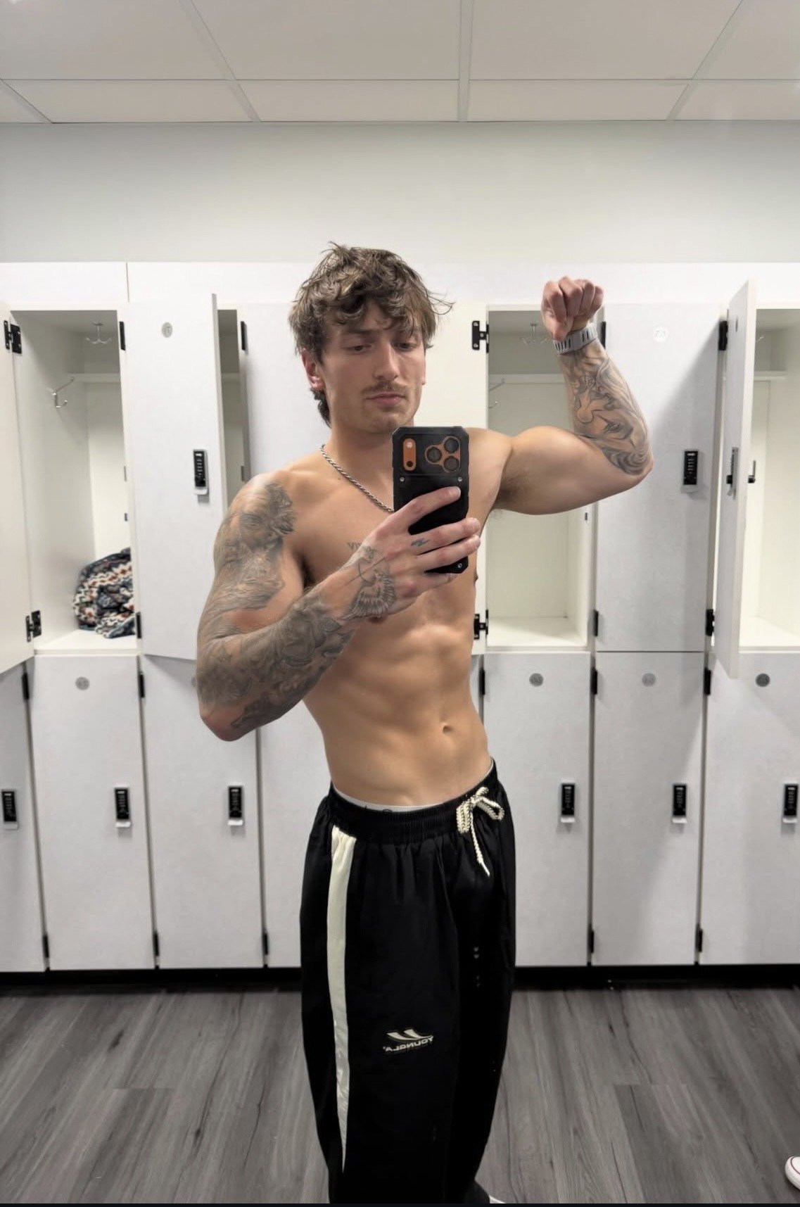 Coach posing in locker room